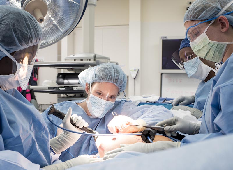 Surgical oncologist Andrea M. Abbott working on a patient. 